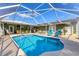 Beautiful screened pool with spacious patio and seating at 7168 Lighthouse St, Englewood, FL 34224