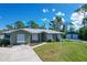 Charming single-story home with green exterior and a two-car garage at 7168 Lighthouse St, Englewood, FL 34224