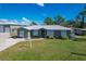 Single-story house with green exterior and landscaping at 7168 Lighthouse St, Englewood, FL 34224