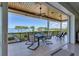 Covered balcony with water views and outdoor seating at 9801 Eagle Preserve Dr, Englewood, FL 34224