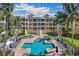 Community pool with surrounding lounge chairs at 14021 Bellagio Way # 311, Osprey, FL 34229