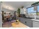 Open concept kitchen and dining area with modern gray cabinets and a sliding barn door at 6367 Facet Ln, Port Charlotte, FL 33981