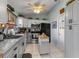 Modern kitchen with stainless steel appliances, gray cabinets and a kitchen island at 6367 Facet Ln, Port Charlotte, FL 33981