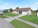 Single story home with brown roof, white exterior, and a screened porch at 6367 Facet Ln, Port Charlotte, FL 33981