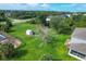 Aerial view showcasing the spacious backyard with shed and the home's proximity to neighborhood at 13401 Galveston Ave, Port Charlotte, FL 33981
