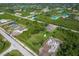 Property aerial showing large lot, new construction next door and neighborhood at 13401 Galveston Ave, Port Charlotte, FL 33981
