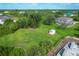 Aerial view of the property showing a large yard, storage shed, and surrounding green landscape at 13401 Galveston Ave, Port Charlotte, FL 33981