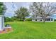 Spacious backyard with lush lawn, mature trees, screened porch and additional shed at 13401 Galveston Ave, Port Charlotte, FL 33981