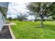 Expansive green backyard featuring mature trees and ample space for outdoor activities at 13401 Galveston Ave, Port Charlotte, FL 33981