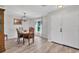 Dining room with wooden table and chairs, a hutch, pendant lighting, and light-colored hardwood floors at 13401 Galveston Ave, Port Charlotte, FL 33981