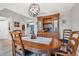 Dining room features wooden table and chairs, decorative hutch, chandelier, and light-colored hardwood floors at 13401 Galveston Ave, Port Charlotte, FL 33981