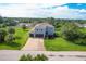 Two-story home featuring a two-car garage, landscaped lawn and a brick walkway leading to the front door at 13401 Galveston Ave, Port Charlotte, FL 33981