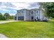 Two-story home featuring a two-car garage, landscaped lawn and front entrance at 13401 Galveston Ave, Port Charlotte, FL 33981