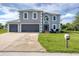 Charming home featuring a spacious lawn, two-car garage, and well-maintained landscaping at 13401 Galveston Ave, Port Charlotte, FL 33981