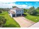 Two-story home with an attached two-car garage, long driveway, and lush green lawn at 13401 Galveston Ave, Port Charlotte, FL 33981