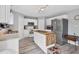 Bright kitchen features white cabinets, modern appliances, an island with wood top, and light-colored hardwood floors at 13401 Galveston Ave, Port Charlotte, FL 33981