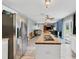 Bright, open-concept living area with lots of natural light and wood-look tile floors at 13401 Galveston Ave, Port Charlotte, FL 33981