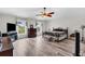 Large primary bedroom with wood-look floors, ceiling fan, and lots of natural light at 13401 Galveston Ave, Port Charlotte, FL 33981