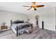 Primary bedroom featuring a walk in closet, wood look floors, and ceiling fan at 13401 Galveston Ave, Port Charlotte, FL 33981