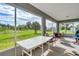 Relaxing screened porch featuring expansive views of the lush backyard and blue sky at 13401 Galveston Ave, Port Charlotte, FL 33981