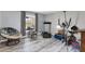Spare room with exercise equipment, a comfortable chair, a window, and light-colored hardwood floors at 13401 Galveston Ave, Port Charlotte, FL 33981