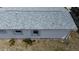 Close up of a building with a new roof, white exterior and updated rain gutters at 317 E Green St, Englewood, FL 34223