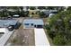 Aerial view of a home with a long driveway and a manicured lawn in a quiet neighborhood at 317 E Green St, Englewood, FL 34223