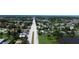 An aerial view of a neighborhood featuring lush greenery and a long main road at 317 E Green St, Englewood, FL 34223