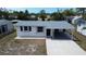 Charming single-story home featuring a new roof, covered carport, and freshly painted exterior at 317 E Green St, Englewood, FL 34223