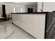 Modern kitchen island with white cabinets and black countertops at 324 Comstock St, Port Charlotte, FL 33954
