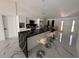 Modern kitchen with large island, stainless steel appliances, and marble floors at 324 Comstock St, Port Charlotte, FL 33954