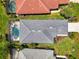 An aerial view of the property shows the house, pool, and surrounding greenery at 3359 Osprey Ln, Port Charlotte, FL 33953