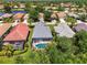 An aerial view shows the property's pool, landscaping, and neighborhood at 3359 Osprey Ln, Port Charlotte, FL 33953