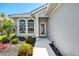 Inviting front entrance with beautifully landscaped garden beds and large windows, creating a warm and welcoming feel at 3359 Osprey Ln, Port Charlotte, FL 33953