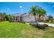 Charming single-story home featuring beautiful landscaping, a well-manicured lawn, and a neutral color palette at 3359 Osprey Ln, Port Charlotte, FL 33953