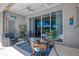 Covered patio features comfortable seating and views of the backyard pool area through sliding glass doors at 3359 Osprey Ln, Port Charlotte, FL 33953