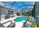Private screened-in pool area features comfortable lounge chairs and well-maintained patio, ideal for outdoor relaxation at 3359 Osprey Ln, Port Charlotte, FL 33953