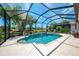 Beautiful screened pool with ample patio space offers a serene outdoor retreat with views of the surrounding landscape at 3359 Osprey Ln, Port Charlotte, FL 33953