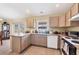 Functional kitchen with a window view, offering ample counter space and essential appliances at 6344 Hera St, Englewood, FL 34224