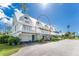 White two-story building with multiple units and balconies at 6800 Placida Rd # Th2, Englewood, FL 34224