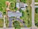 An aerial view displays a single-Gathering home, a circular driveway, and mature landscaping at 797 Michigan Ave, Englewood, FL 34223