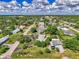 Expansive aerial view showcases the neighborhood with lush greenery, single-Gathering homes, and blue skies at 797 Michigan Ave, Englewood, FL 34223