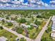 Aerial view of the neighborhood with lush greenery, a nearby lake, and single-Gathering homes at 797 Michigan Ave, Englewood, FL 34223