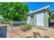 Exterior backyard of property with mature landscaping, small building and chainlink fence at 797 Michigan Ave, Englewood, FL 34223