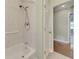 Cozy bathroom featuring a standard tub, shower head, and easy access hand rail at 797 Michigan Ave, Englewood, FL 34223