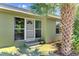 Inviting front entrance with mature landscaping and a charming front door at 797 Michigan Ave, Englewood, FL 34223