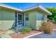 The front entrance features a screened porch and well-maintained landscaping at 797 Michigan Ave, Englewood, FL 34223