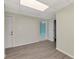A hallway with gray vinyl floors, light green walls, and two white doors at 797 Michigan Ave, Englewood, FL 34223