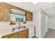 A kitchen with wood cabinets, laminate countertop, and a stainless steel sink at 797 Michigan Ave, Englewood, FL 34223