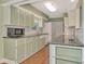 An eat-in kitchen with sleek counters, tile backsplash, and stainless steel appliances at 797 Michigan Ave, Englewood, FL 34223